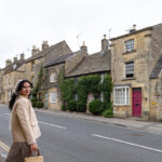 woman standing in front of cottages